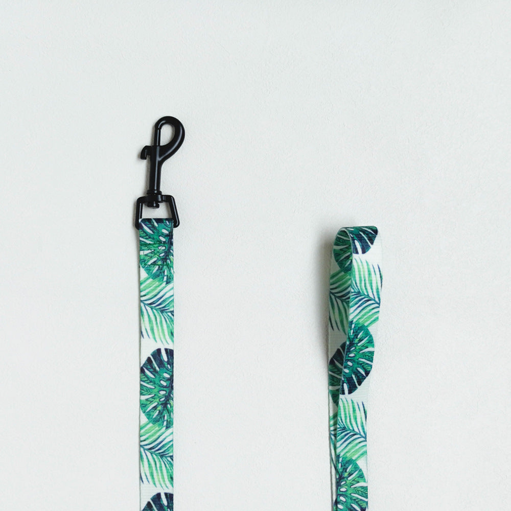 Tropical leaf patterned strap with clip on a white background