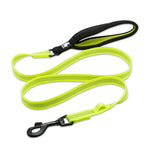 Neon green dog leash with black clip on a white background
