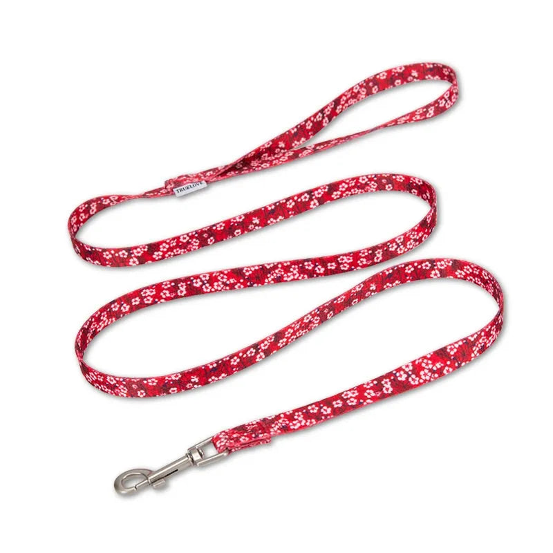 Red floral patterned dog leash on a white background