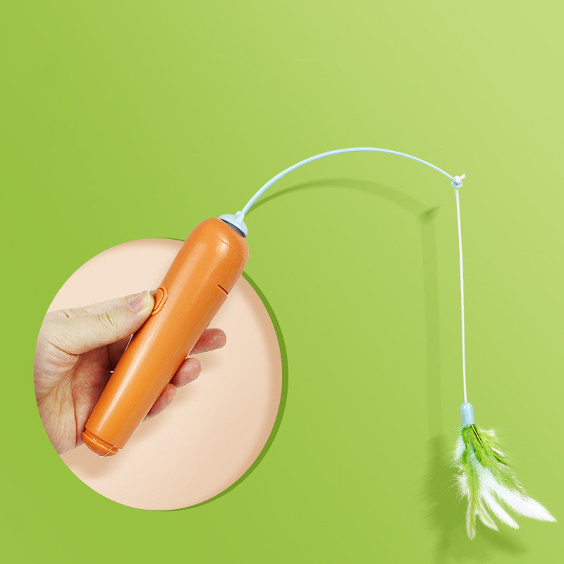 Orange electronic pet toy with a string and feathers on a green background