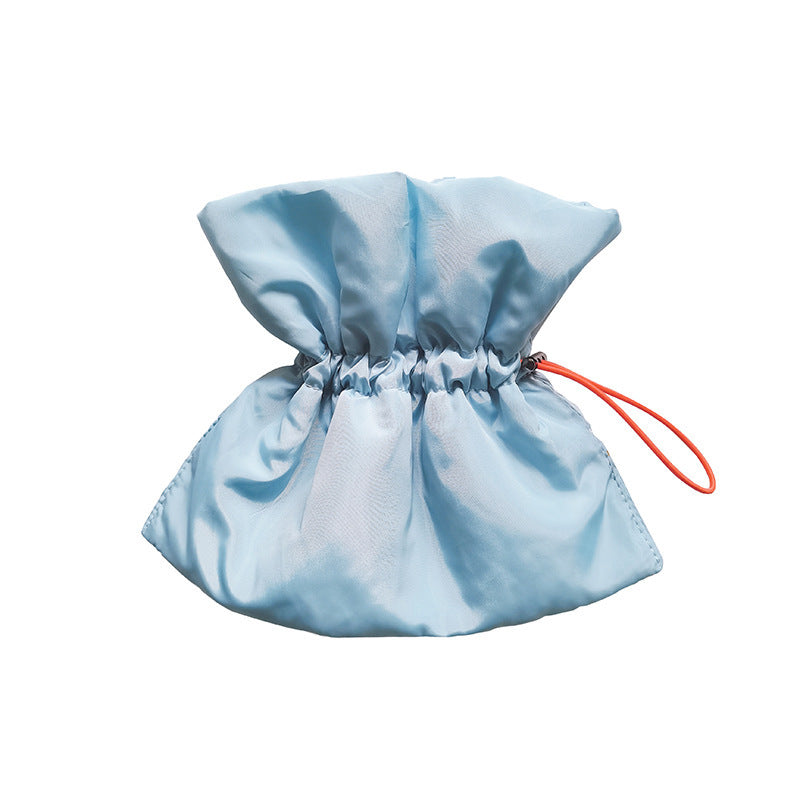 Light blue drawstring bag with a red string on a white background