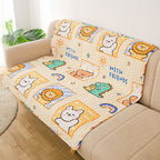 Children's cartoon blanket with animals and 'WITH FRIENDS' text on a beige couch.