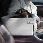 A portable car central dog seat bed, with small dogs inside, being used in a vehicle setting. The bed is shown in different angles, highlighting its design and use.