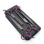 Set of black and purple hairdressing scissors in a black case on a white background