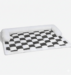 Checkered pet bed with white border on a white background